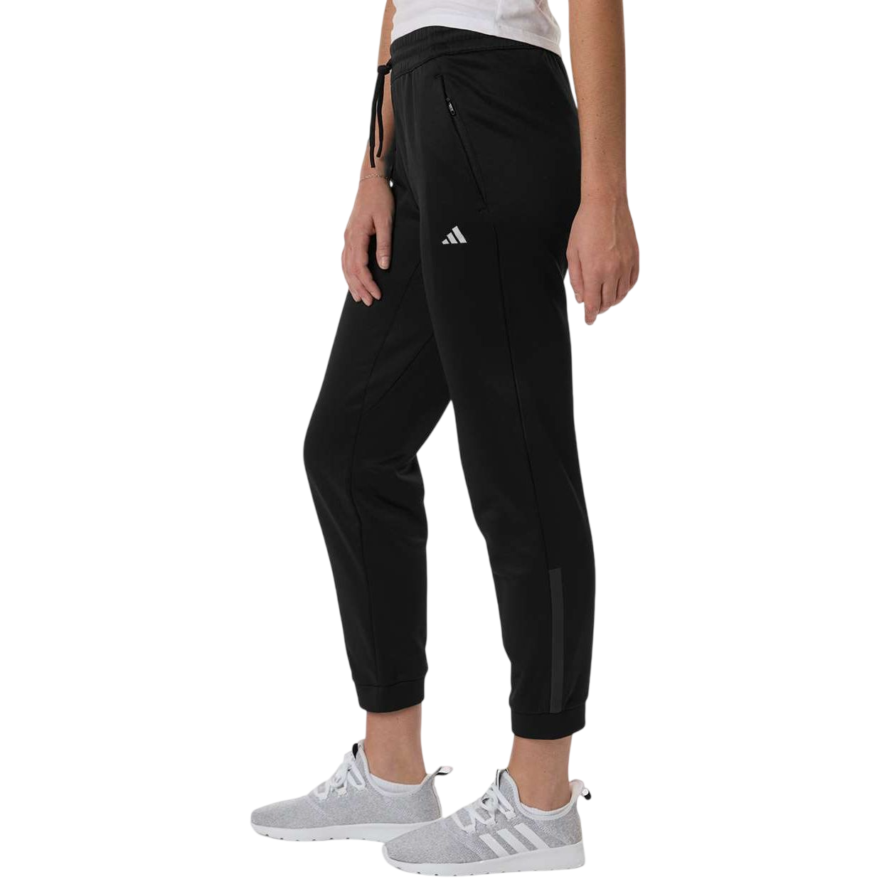 Black adidas Women’s Game & Go Fleece Sweatpants in black recycled polyester fleece with elastic drawcord waistband, zippered side pockets, and heat-seal logo, designed for athletic training and casual comfort.