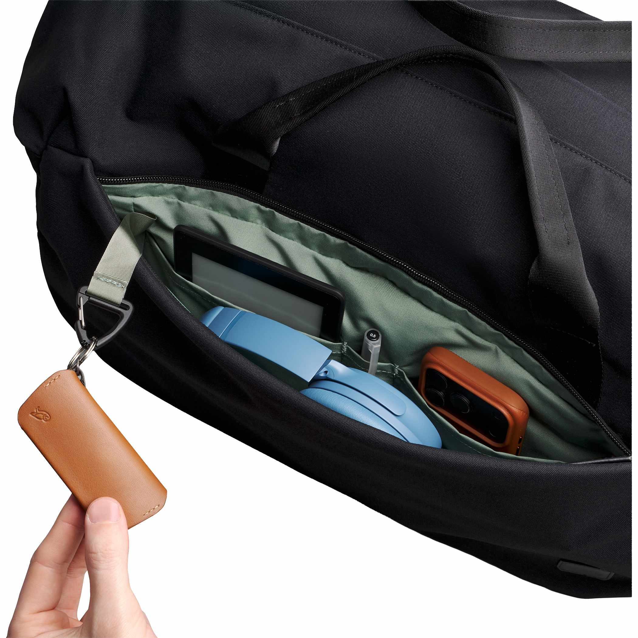 Black Bellroy Classic 45L Duffle Bag in black Canva Weave fabric packed with clothing and travel essentials, featuring a wide-opening barrel design, organized interior pockets, and spacious storage for weekend travel and everyday carry.
