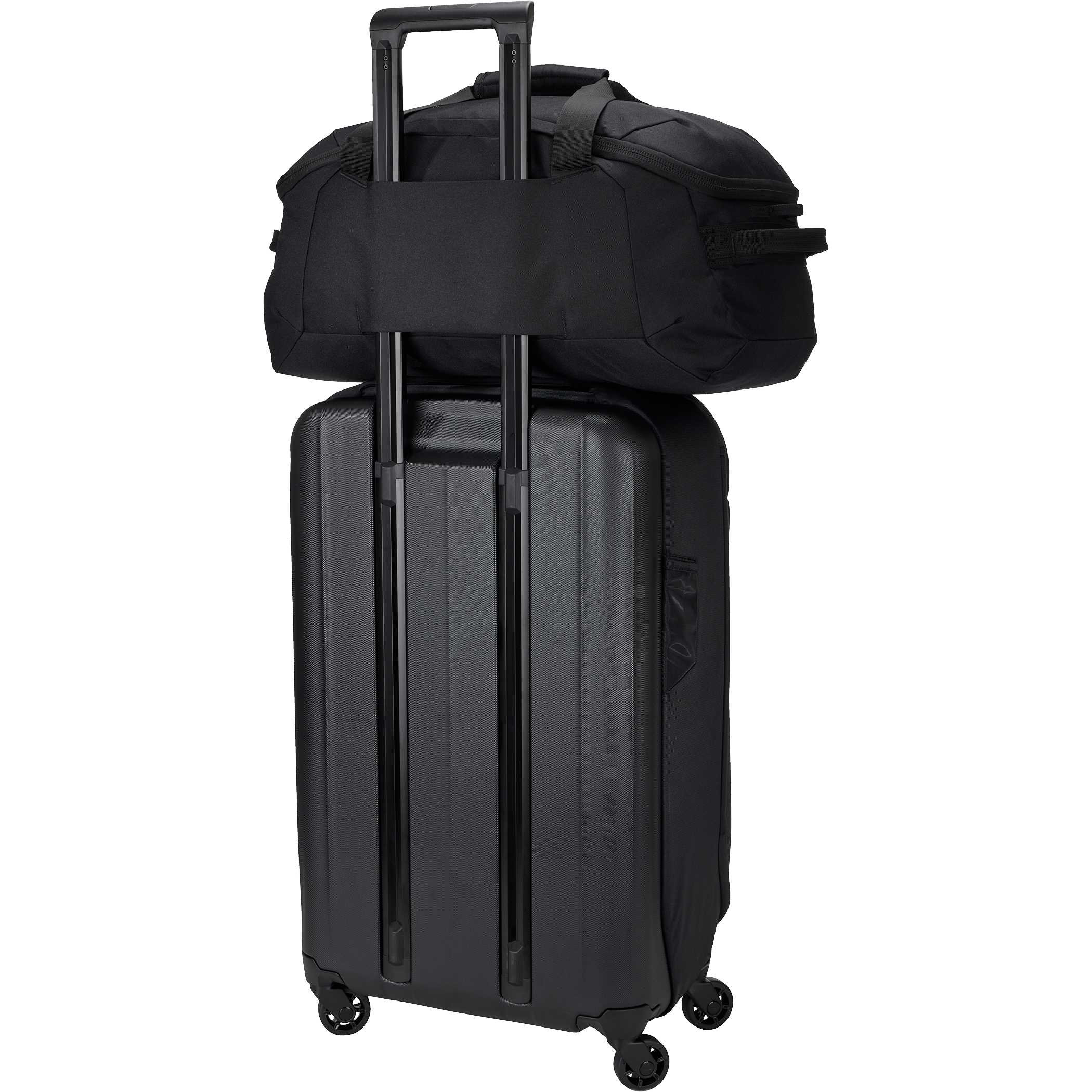 Black Thule Lumion Duffle 9020-67 lifestyle view showing the black travel duffel resting on the luggage in a travel-ready scene, highlighting its practical size, side pocket storage, and easy-access opening for packing essentials.