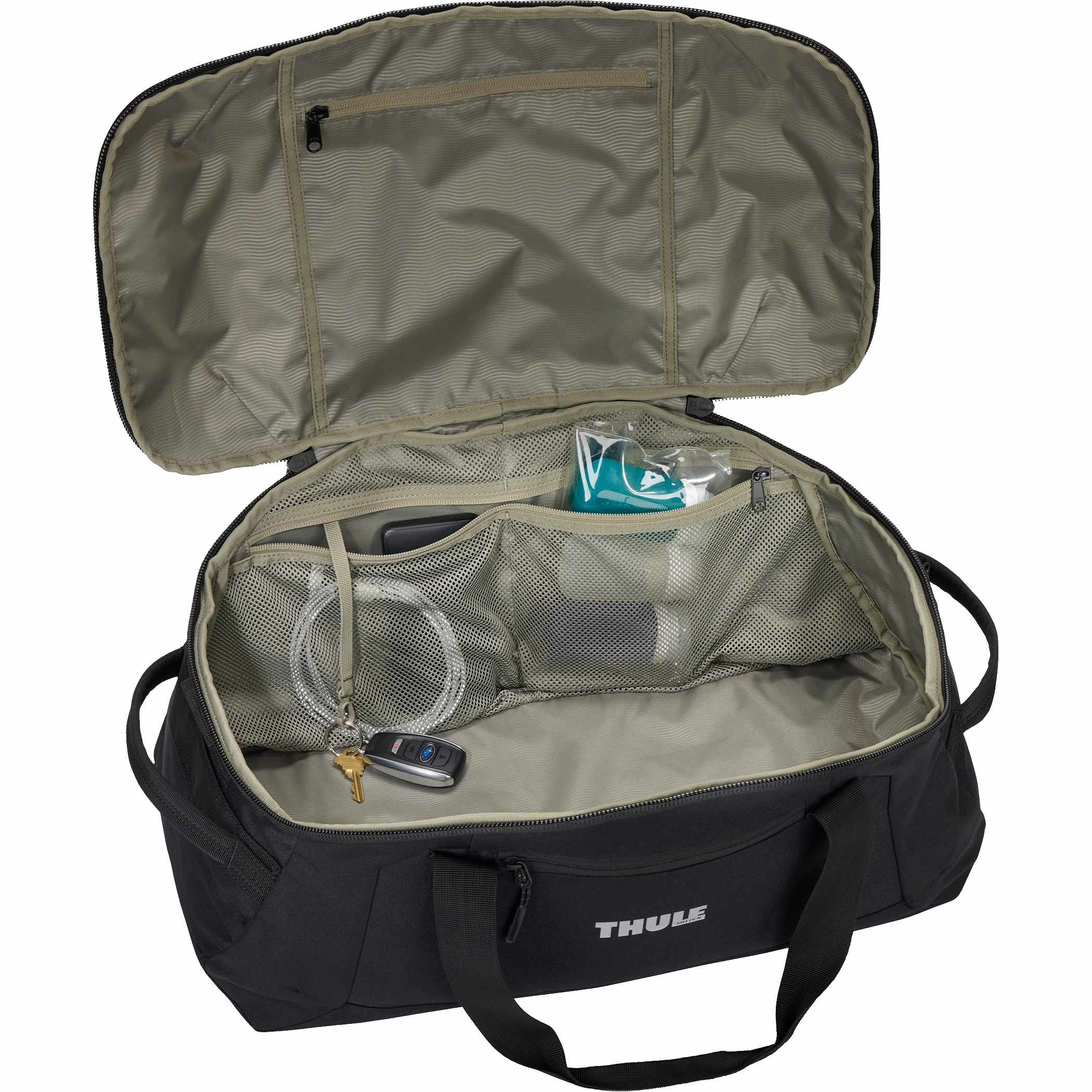 Thule Lumion Duffle in black recycled polyester material placed in a modern travel setting, shown as a spacious duffel bag with structured shape and front zippered pocket designed for organized packing and travel use.