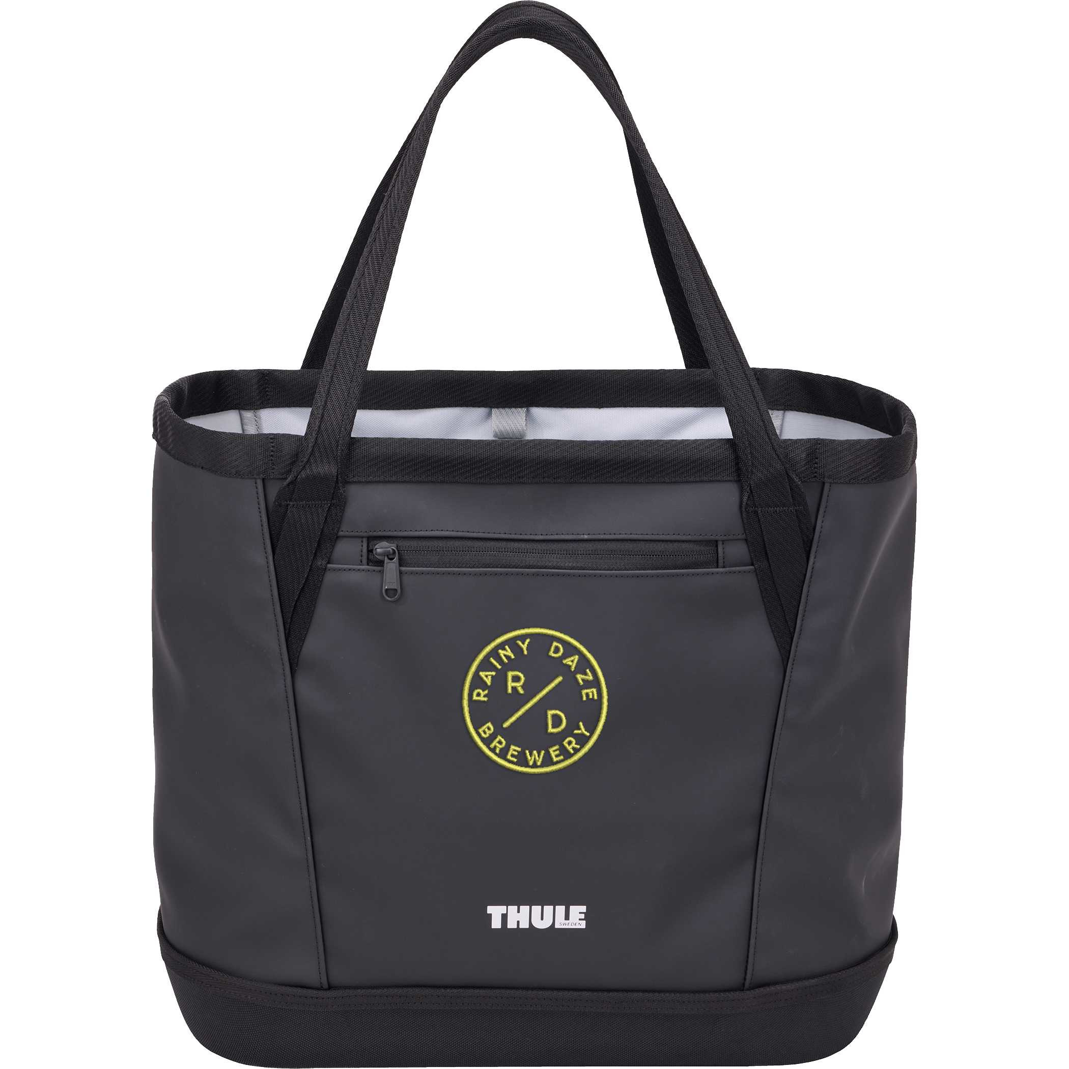 Thule 30L Chasm Gear Tote in black durable weather-resistant fabric with structured tote design, featuring a spacious main compartment, exterior zippered pocket, and sturdy carry handles for everyday use and travel storage.