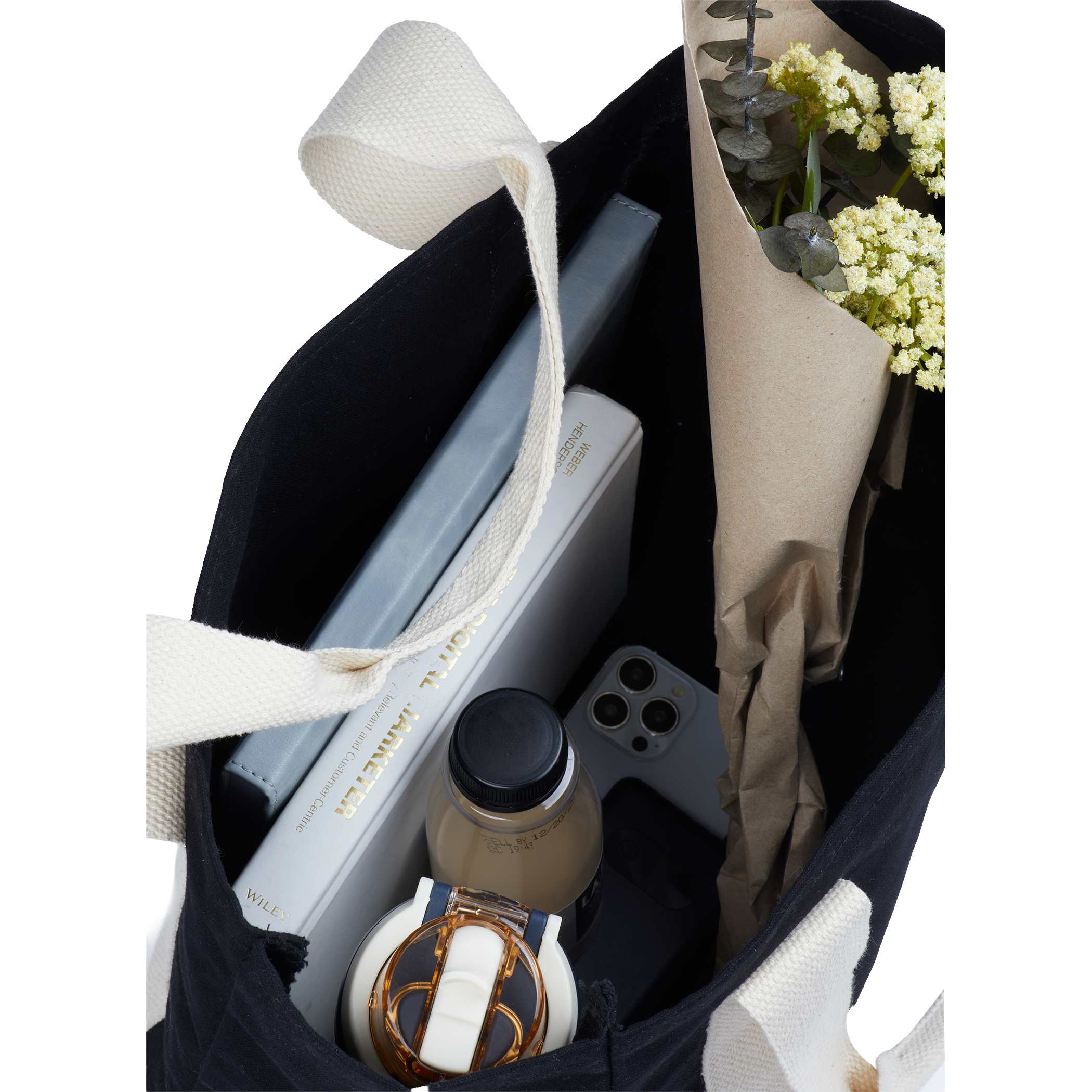 12oz Cotton Shopper Tote with Contrast Handles in natural organic cotton with black contrast webbing handles, shown in a lifestyle setting styled with everyday carry items, highlighting its spacious open compartment and use for shopping, commuting, or carrying daily essentials.