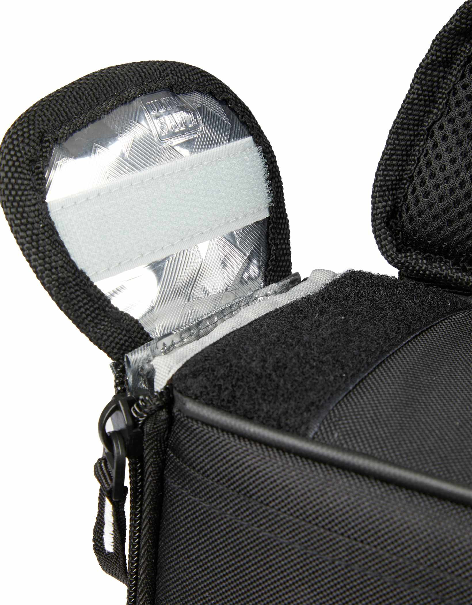 Arctic Zone Rolltop Cinch Cooler in black insulated fabric with roll-top closure and adjustable shoulder straps, shown in a lifestyle outdoor setting on a picnic table alongside food and drinks, highlighting its use as a portable cooler for travel, picnics, and outdoor gatherings.