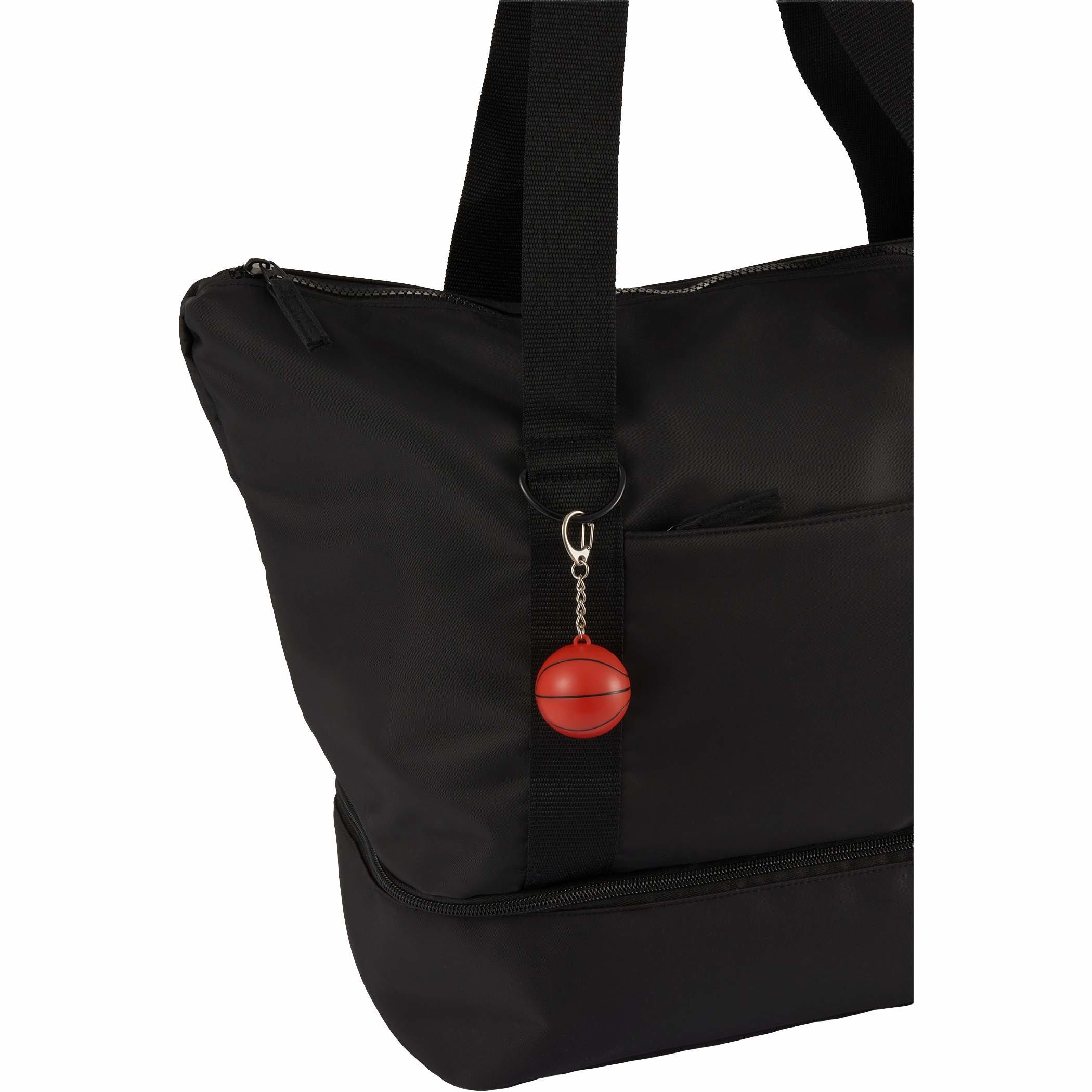 Black bag with dual carry handles, zippered bottom compartment, and Basketball SPF15 Lip Balm Keychain with orange basketball-shaped recycled plastic case clipped to a sports bag beside a water bottle and basketball gear, highlighting portable lip care for outdoor activities and team events, attached to the front strap for sports-themed travel or lunch storage.