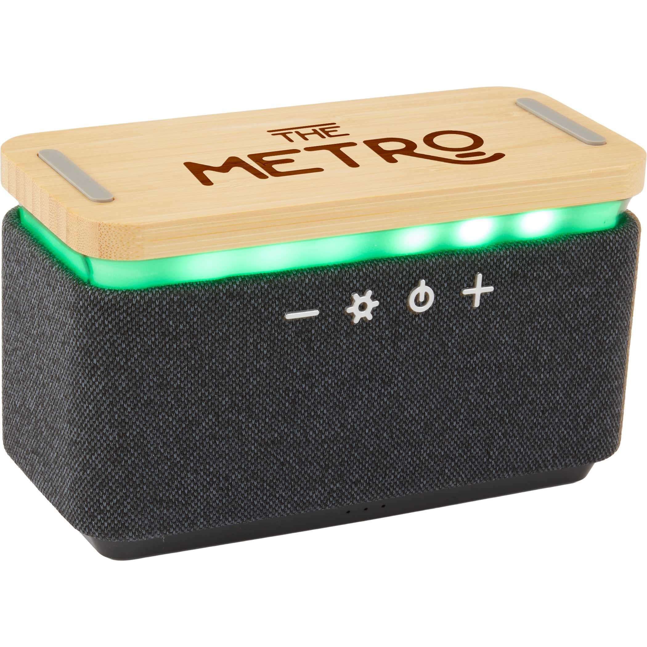 Natural/Gray Boost Fabric & FSC® Bamboo Speaker with Wireless Charging Pad featuring a natural bamboo top, gray RPET fabric wrap, built-in wireless charging surface, multi-color light accents, and compact speaker design for wireless audio playback and device charging.