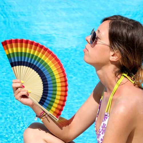 Rainbow accordion folding fan with colorful polyester fan panels and natural bamboo handle designed for portable cooling and outdoor events.