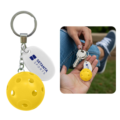 Yellow pickleball keychain featuring a miniature plastic pickleball attached to a durable metal keyring for everyday carry.