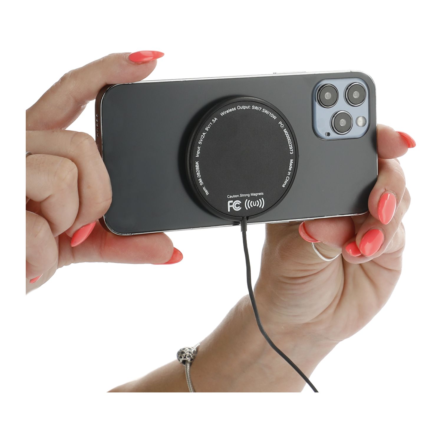 MagClick® Fast Wireless Charging Pad in use with compatible iPhone