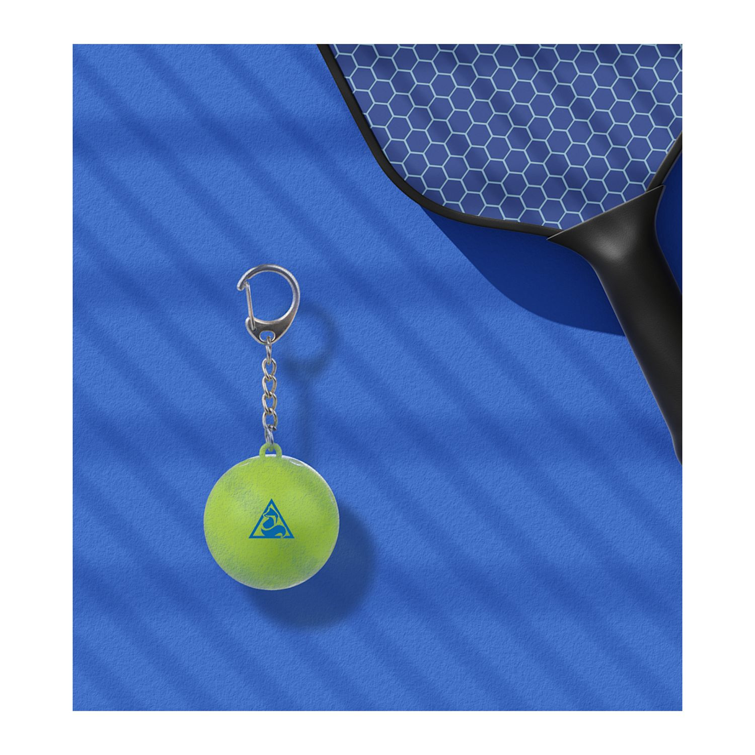 Green pickleball-shaped SPF15 lip balm keychain made from 100% recycled ABS plastic with attached keyring and custom logo imprint on the front.