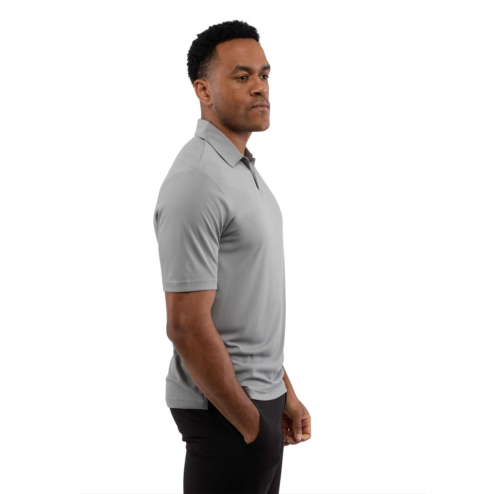 A man wearing a Quarry Men’s Dara Recycled Tech Polo made from structured recycled polyester fabric during an outdoor event. The short-sleeve polo features a modern two-snap button placket, clean snag-resistant texture, and an athletic fit, showcasing its use as professional corporate apparel.