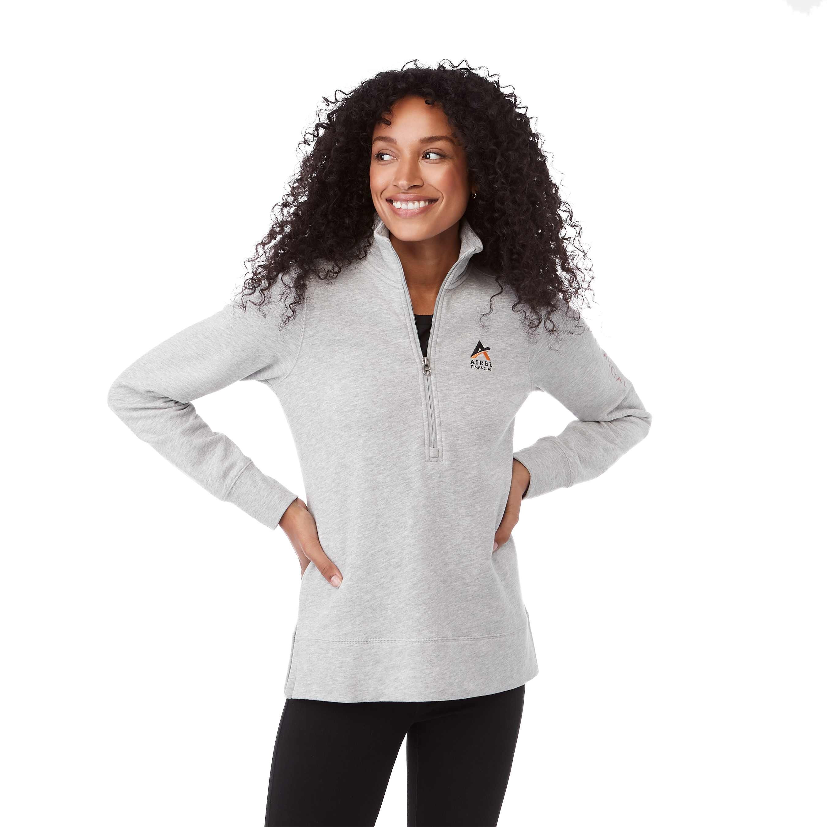 A woman wearing Heather Gray Secondary Dayton Classic Fleece Half Zip Pullover featuring a soft cotton-polyester fleece fabric, stand collar with half-zip front, long sleeves, and rib-knit cuffs and hem, designed for comfortable everyday layering and casual wear.