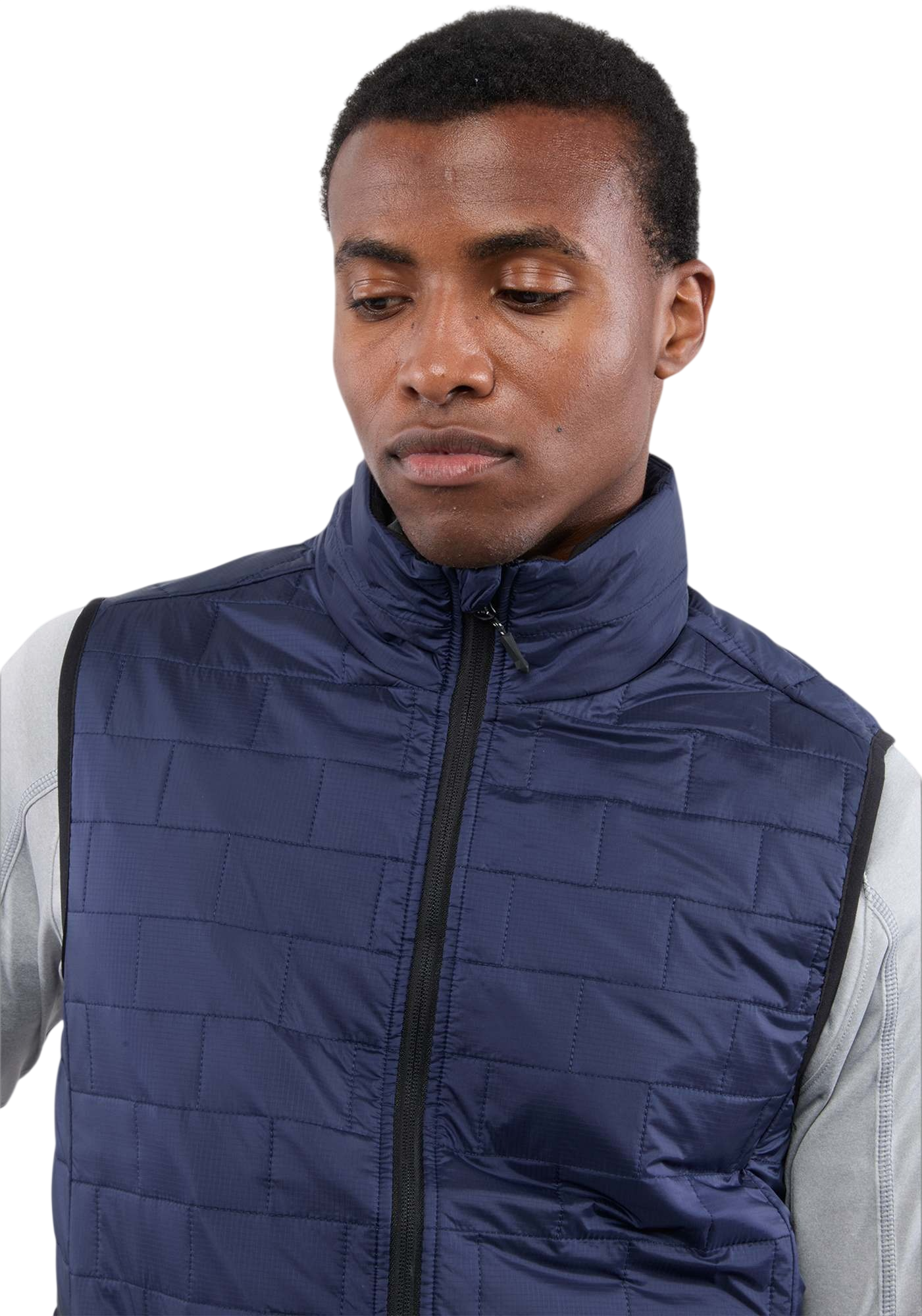 A man wearing the Men's Telluride Packable Insulated Vest in Vintage Navy, featuring a lightweight quilted nylon ripstop shell, full-zip front, stand collar, and zippered pockets, designed for comfortable layering and everyday outdoor wear.