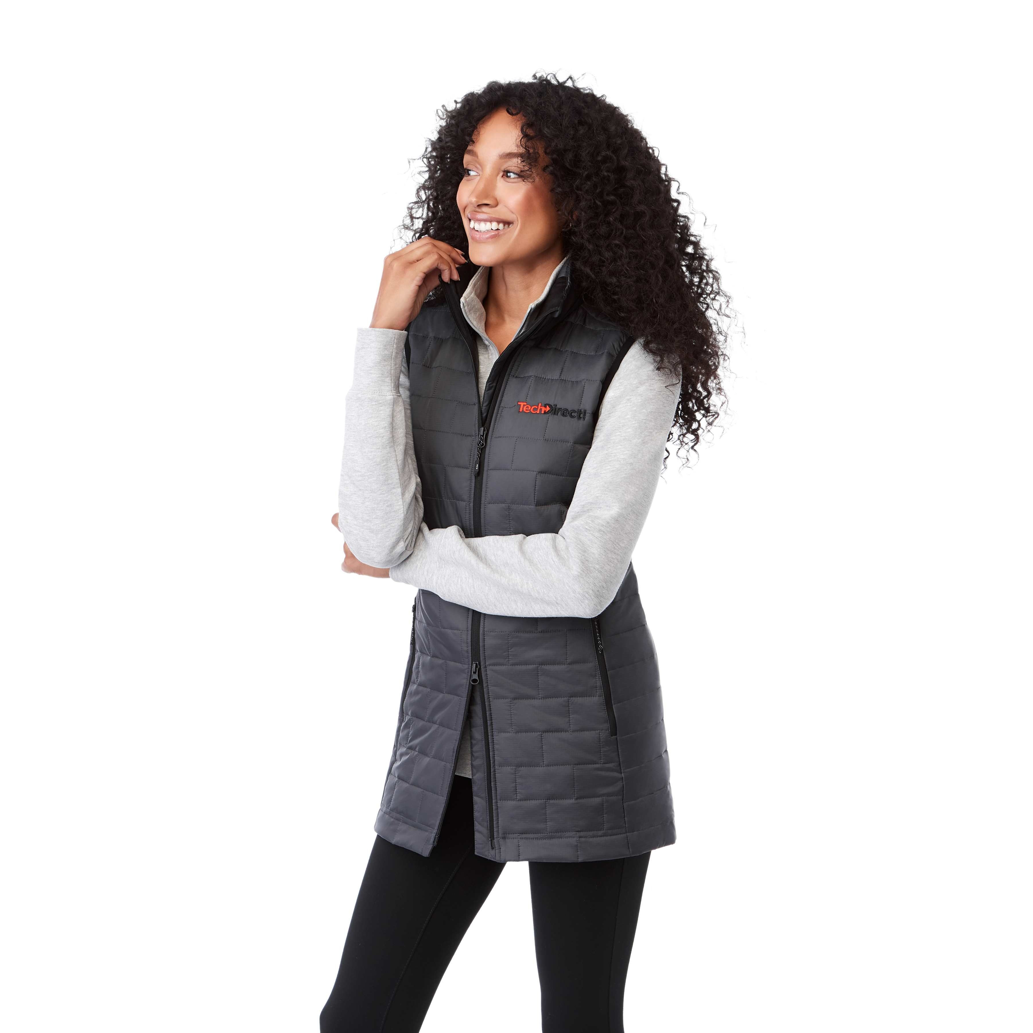 A woman wearing the Women's Telluride Packable Insulated Vest in Gray Storm, featuring a lightweight quilted nylon ripstop shell, full-zip front, stand collar, and zippered pockets, designed for comfortable layering and everyday outdoor wear.