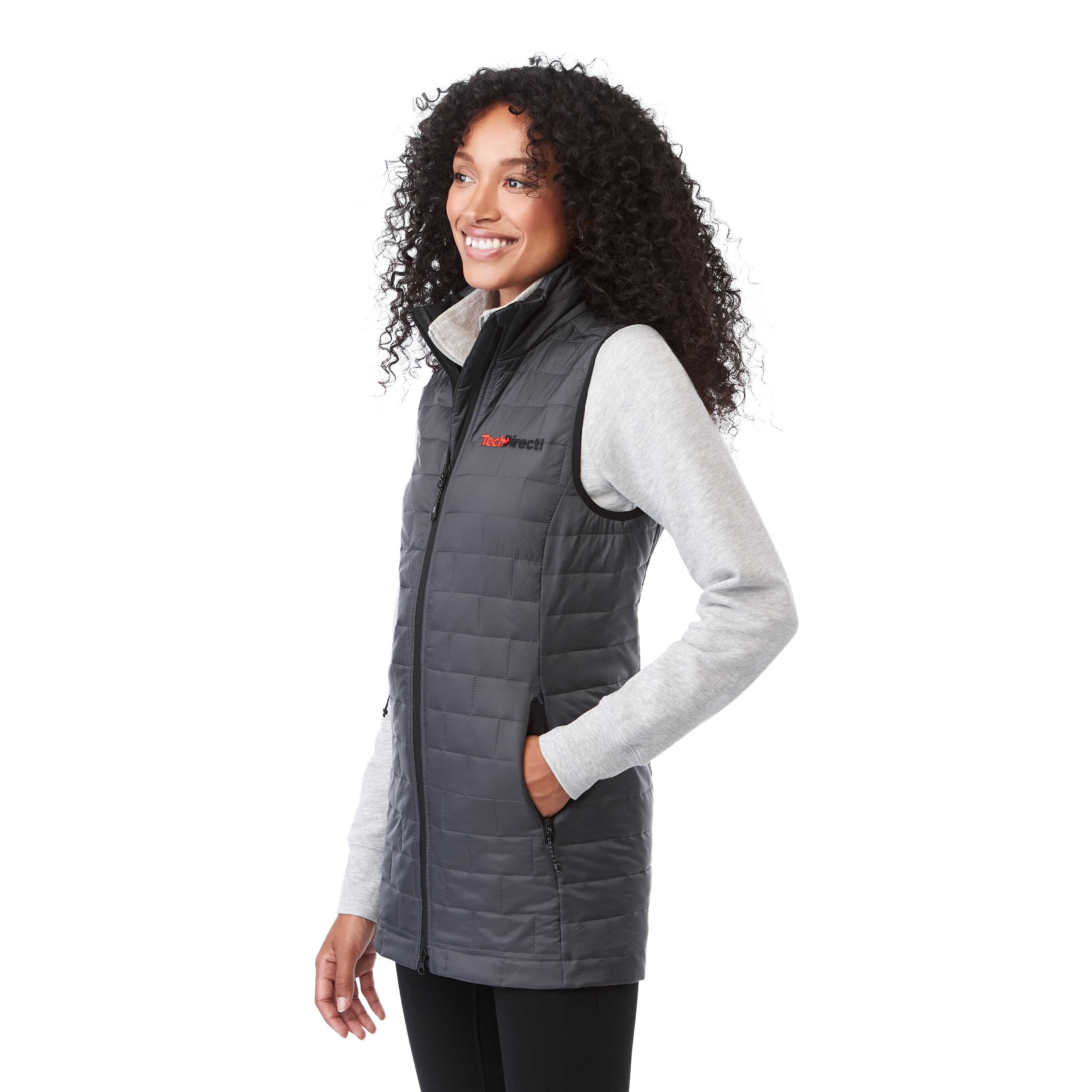 A woman wearing the Women's Telluride Packable Insulated Vest in Gray Storm, featuring a lightweight quilted nylon ripstop shell, full-zip front, stand collar, and zippered pockets, designed for comfortable layering and everyday outdoor wear.