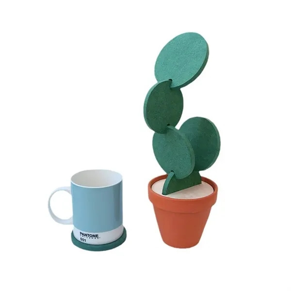 Green cactus-shaped EVA coaster with non-slip surface and heat-insulating construction designed to protect tables from scratches, moisture, and heat.