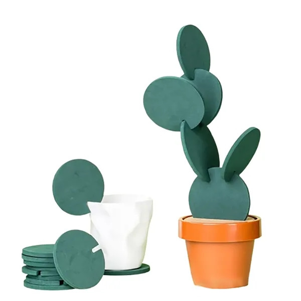 Green cactus-shaped EVA coaster with non-slip surface and heat-insulating construction designed to protect tables from scratches, moisture, and heat.