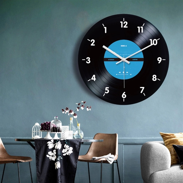 Black vinyl record-style wall clock with classic album-inspired design, analog clock face, and decorative display for home or office décor.