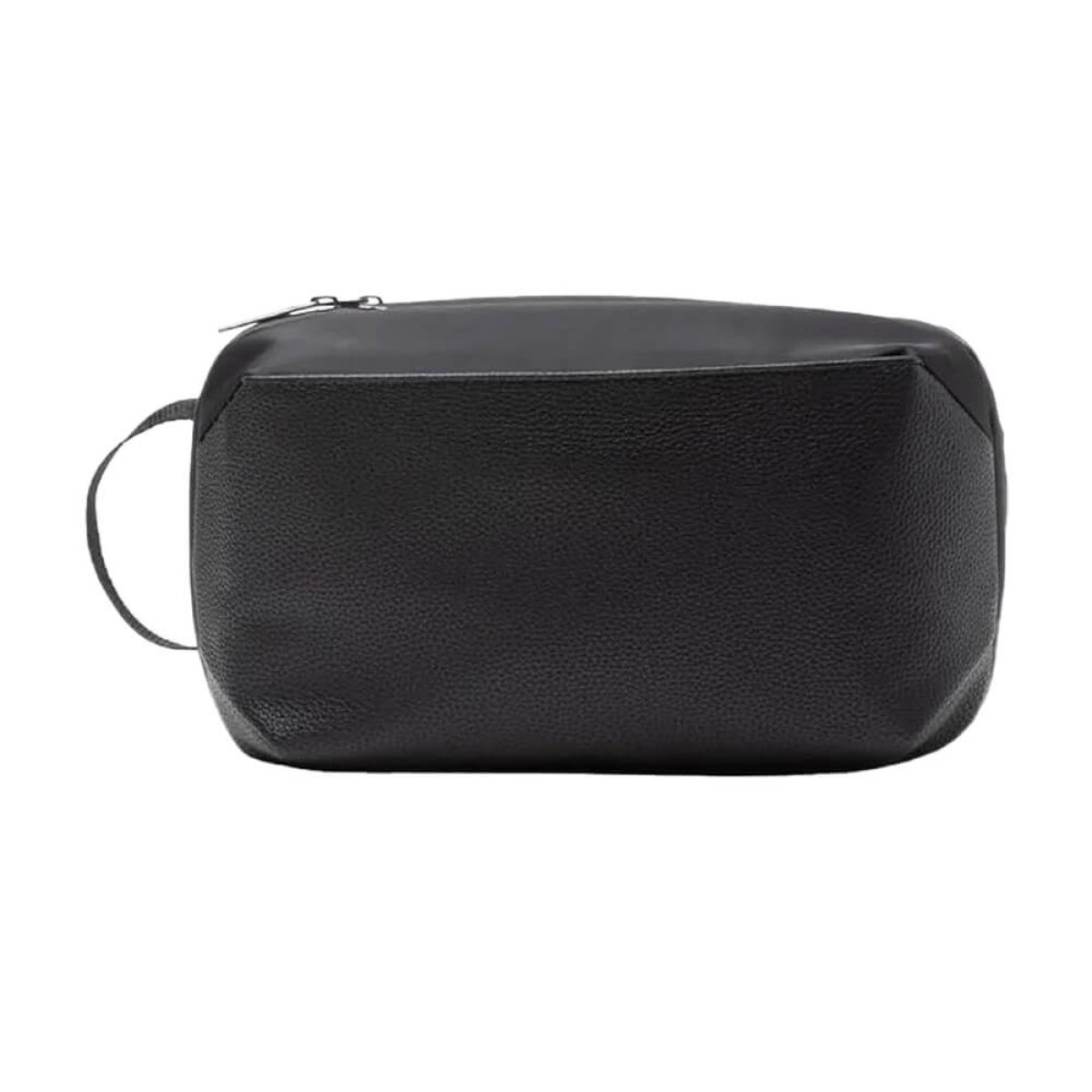 Brookstone Compact Toiletry Kit vegan leather travel bag in black with zippered main compartment, exterior zip pocket, and side grab handle, designed for organizing toiletries and personal care essentials during travel.