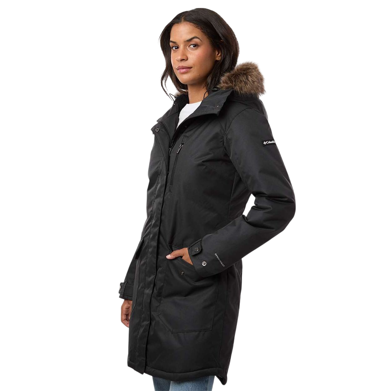 Black Columbia Women’s Suttle Mountain Long Insulated Jacket, a long black polyester winter jacket with an attached hood, faux fur trim, front zipper, and Columbia sleeve patch.