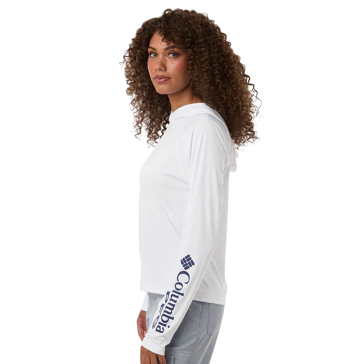 White/Nightshade Columbia Women's PFG Tidal Tee™ Hooded Long Sleeve, featuring lightweight performance fabric with long sleeves, an attached hood, and a blue gradient fish-inspired graphic for sun protection and fishing activities.