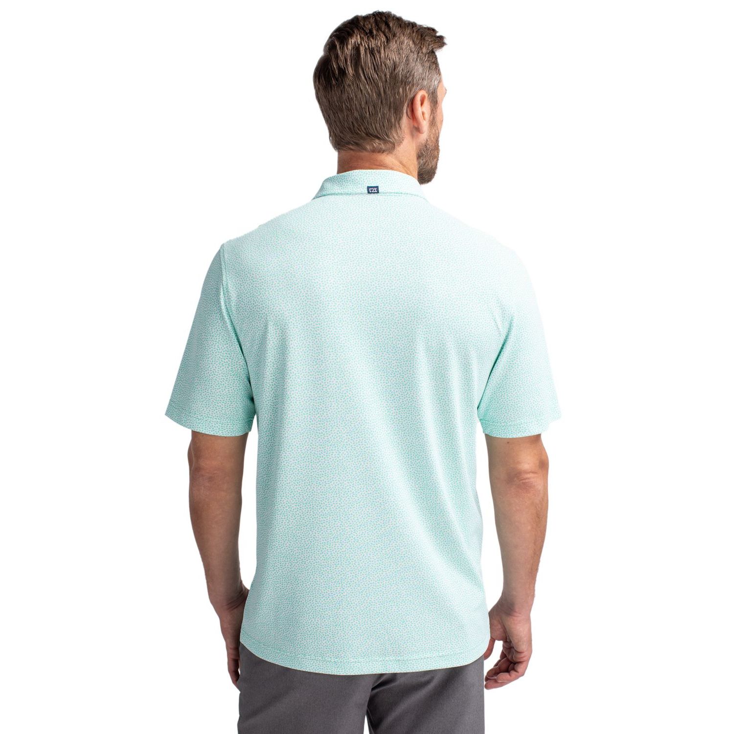Fresh Mint Cutter & Buck Virtue Recycled Botanical Print Featherlight Pique Men’s Polo, featuring lightweight recycled stretch pique fabric with a subtle all-over botanical print, self-fabric collar, three-button placket, short sleeves, and a modern athletic fit designed for golf, travel, work, and everyday wear. The performance fabric offers moisture-wicking comfort, four-way stretch, and UPF 25+ sun protection.