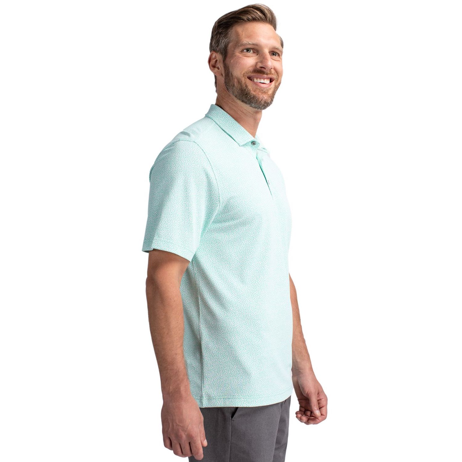 Fresh Mint Cutter & Buck Virtue Recycled Botanical Print Featherlight Pique Men’s Polo, featuring lightweight recycled stretch pique fabric with a subtle all-over botanical print, self-fabric collar, three-button placket, short sleeves, and a modern athletic fit designed for golf, travel, work, and everyday wear. The performance fabric offers moisture-wicking comfort, four-way stretch, and UPF 25+ sun protection.