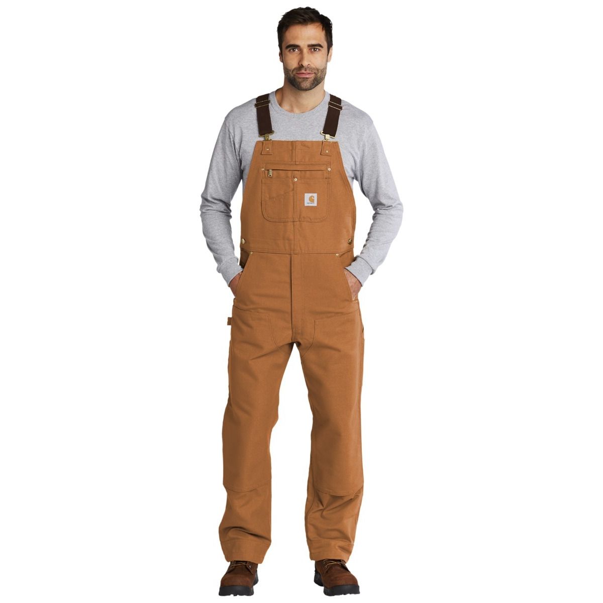 Carhartt Brown Carhartt® Duck Unlined Bib Overalls, featuring durable heavyweight cotton duck canvas, adjustable elastic suspenders, multiple utility pockets, double-front reinforced knees, and a relaxed fit designed for construction, job sites, and everyday workwear.