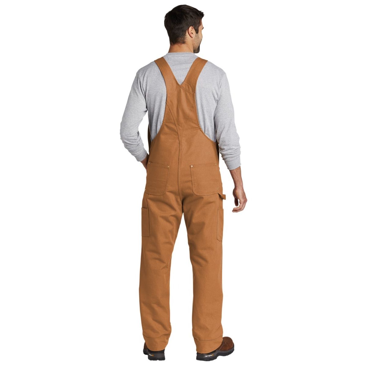 Carhartt Brown Carhartt® Duck Unlined Bib Overalls, featuring durable heavyweight cotton duck canvas, adjustable elastic suspenders, multiple utility pockets, double-front reinforced knees, and a relaxed fit designed for construction, job sites, and everyday workwear.