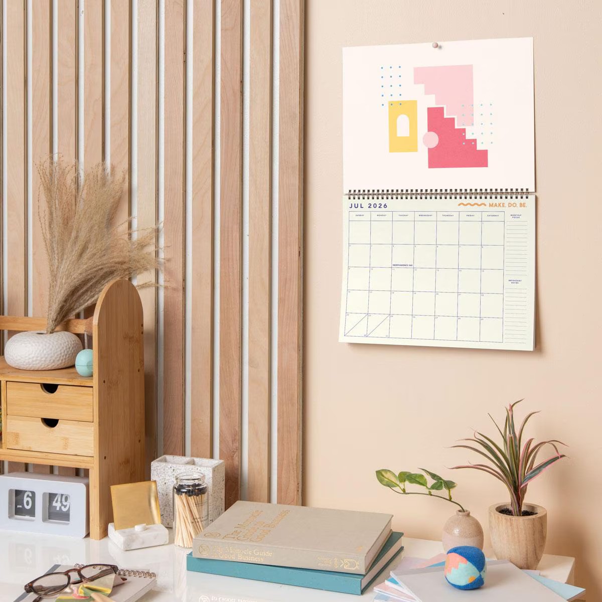 Large horizontal wall calendar with colored page edges and durable text-weight paper.