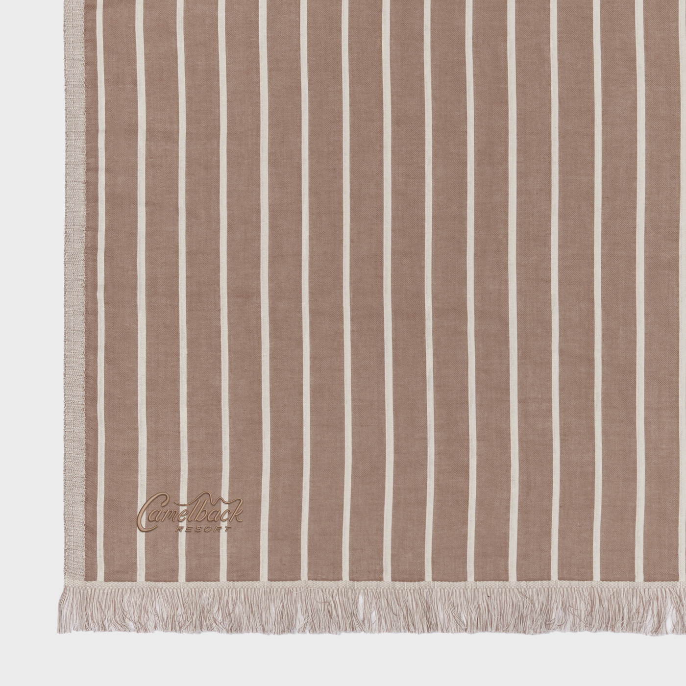 Koko Mousse Slowtide® Driftweave Beach Blanket featuring a woven recycled fabric with a striped pattern, fringed edges, and a lightweight oversized design for the beach, picnics, camping, and outdoor lounging.