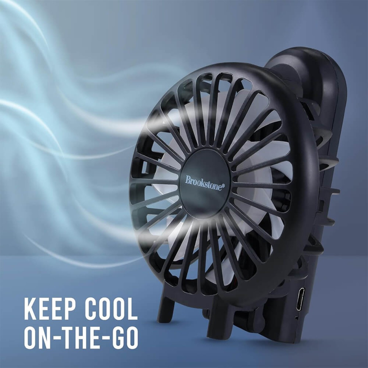 Black Brookstone® Handheld Portable Fan, compact rechargeable plastic personal fan with a round multi-blade fan head, ergonomic handle, and portable design for cooling at home, the office, travel, and outdoor activities.