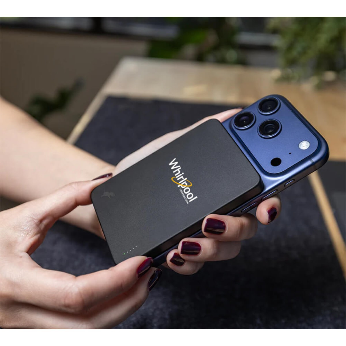 Black Nimble CHAMP Wireless 5K Magnetic Portable Charger, compact magnetic wireless power bank with a smooth rounded design, USB-C charging port, and pocket-sized profile for wirelessly charging MagSafe-compatible smartphones and USB-C devices on the go.