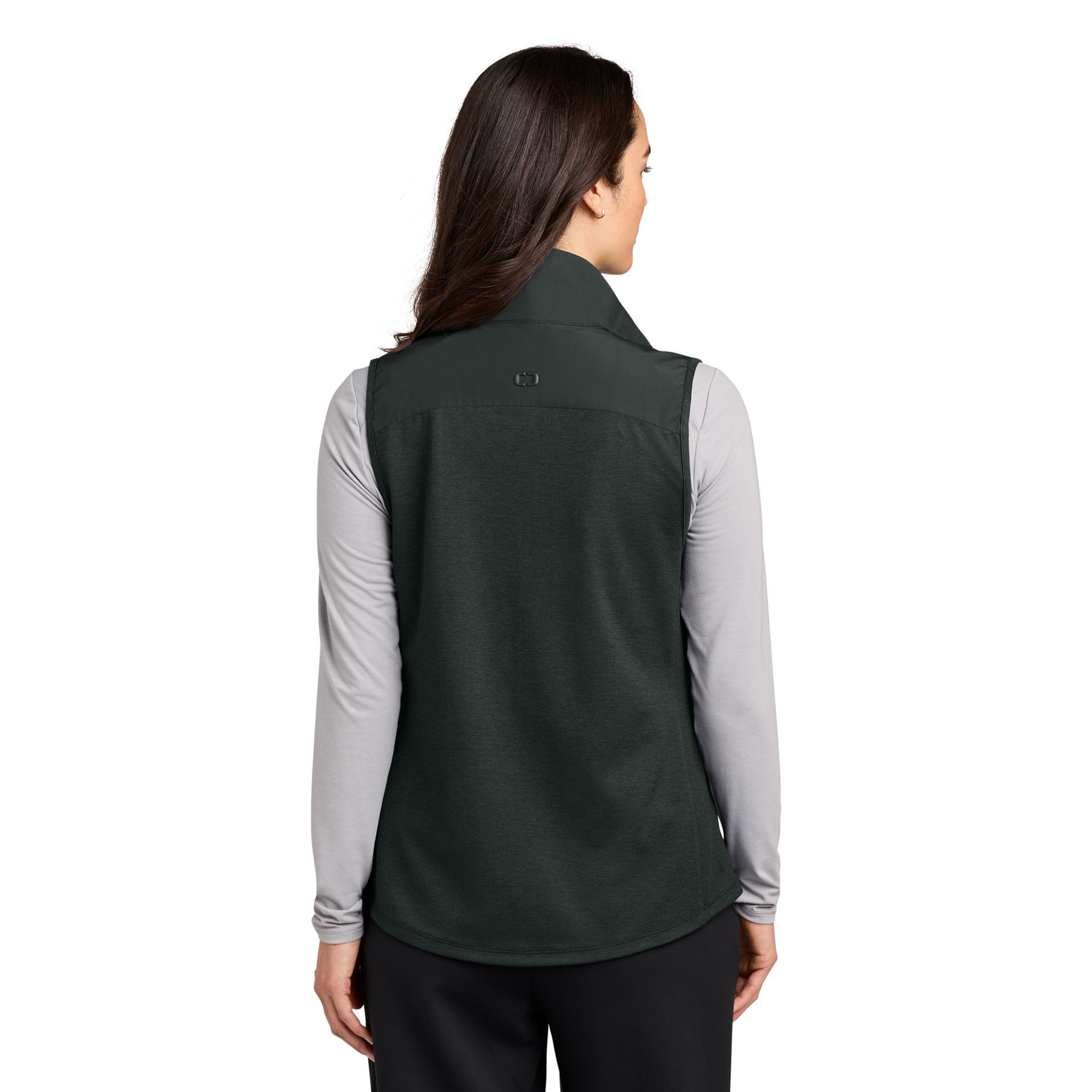 Blacktop OGIO® Women’s Driveline Hybrid Vest a lightweight hybrid vest with a quilted water-repellent front and back, stretch knit side panels for mobility, full-length two-way zipper, zippered hand pockets, stand collar, and a flattering curved hem, designed for layering, travel, work, golf, and outdoor activities.