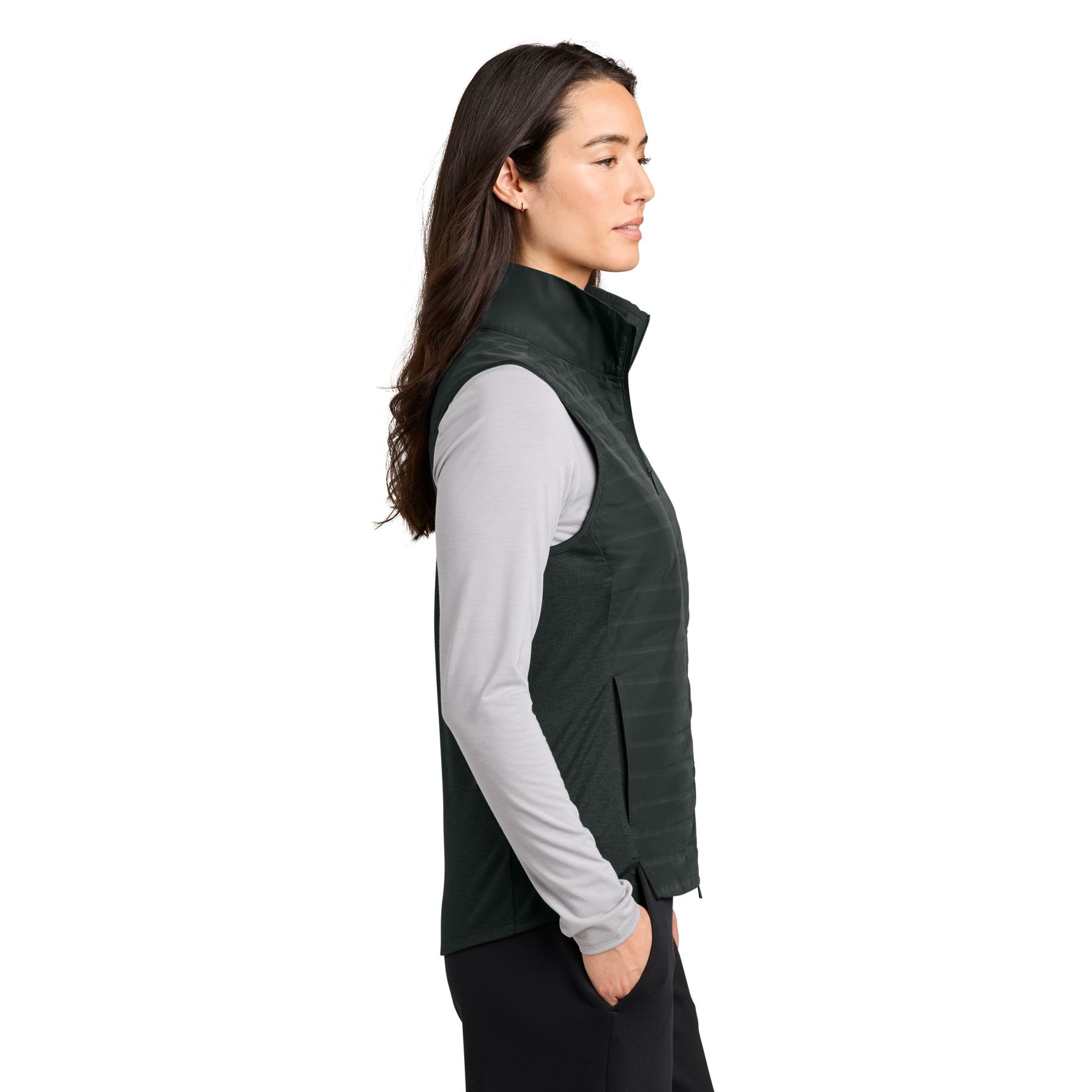Blacktop OGIO® Women’s Driveline Hybrid Vest a lightweight hybrid vest with a quilted water-repellent front and back, stretch knit side panels for mobility, full-length two-way zipper, zippered hand pockets, stand collar, and a flattering curved hem, designed for layering, travel, work, golf, and outdoor activities.