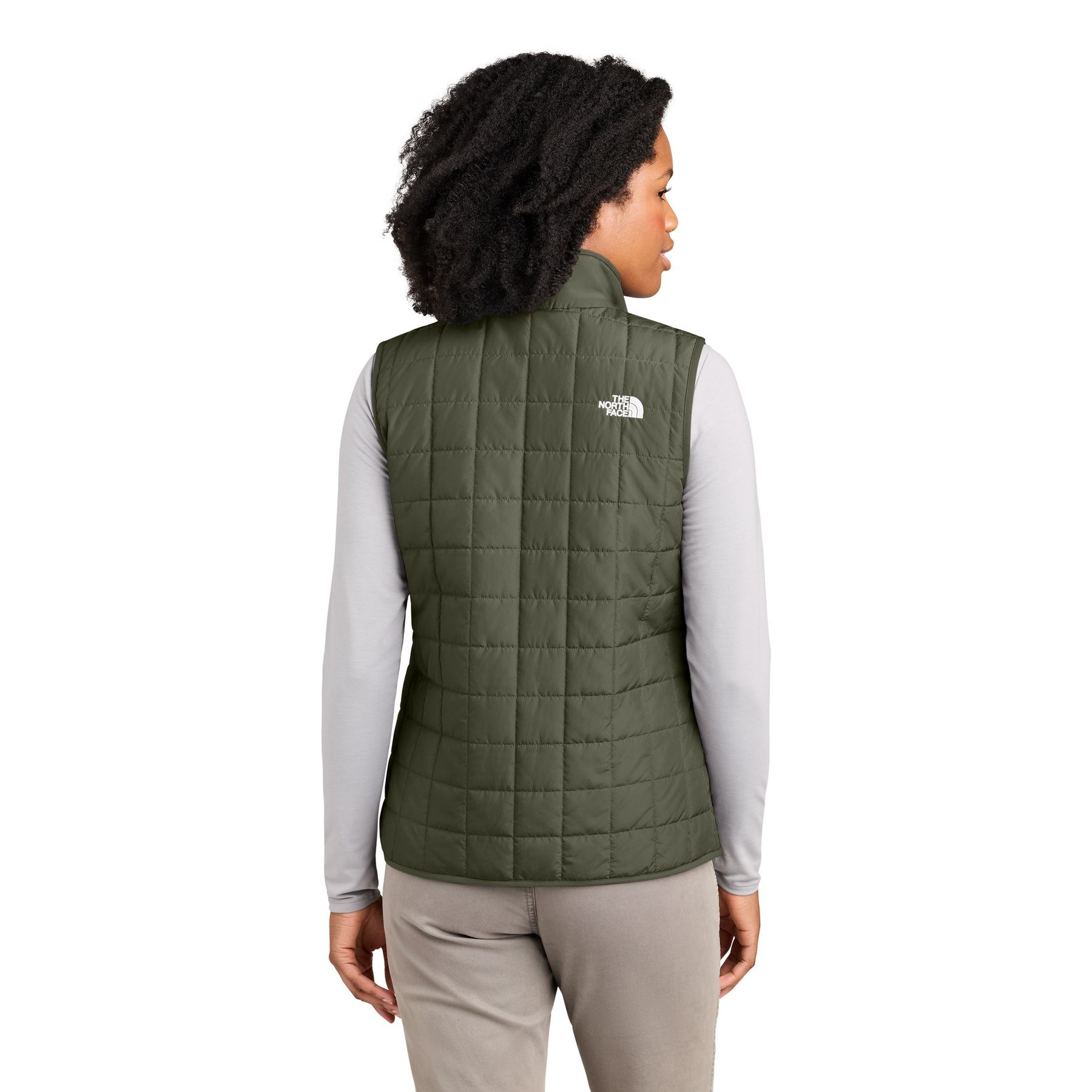 New Taupe Green The North Face® Women’s Iron Drift Quilted Vest a lightweight insulated quilted vest with a recycled polyester shell, non-PFC durable water-repellent finish, full-length reverse-coil zipper, stand collar, secure zippered hand pockets, stretch-bound armholes, and embroidered The North Face® logos, designed for lightweight warmth, layering, commuting, and everyday outdoor wear.