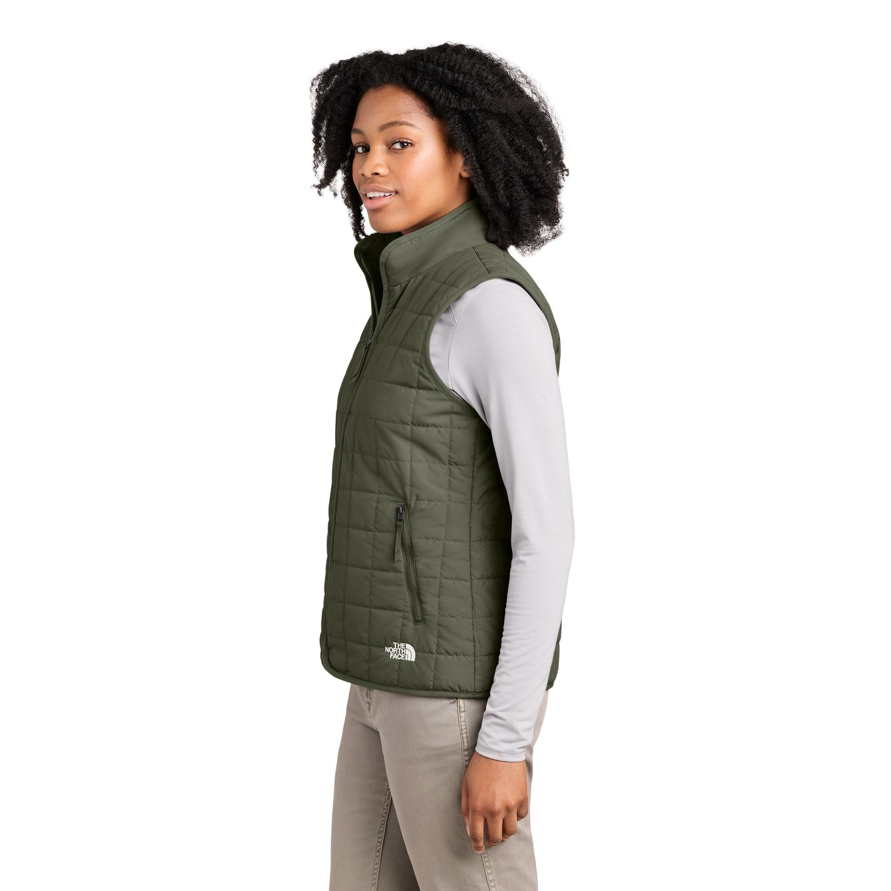 New Taupe Green The North Face® Women’s Iron Drift Quilted Vest a lightweight insulated quilted vest with a recycled polyester shell, non-PFC durable water-repellent finish, full-length reverse-coil zipper, stand collar, secure zippered hand pockets, stretch-bound armholes, and embroidered The North Face® logos, designed for lightweight warmth, layering, commuting, and everyday outdoor wear.