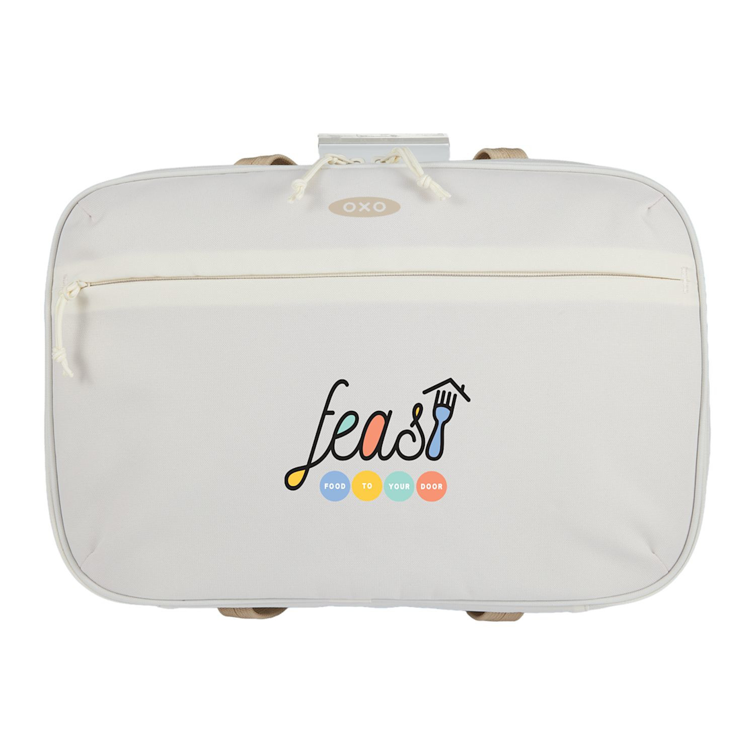 Tan OXO Good Grips Insulated Bakeware Carrier with durable exterior fabric, insulated interior with aluminum lining, generous carry handles, and a front zippered pocket, designed to transport 9 x 13-inch bakeware and keep hot or cold dishes at temperature during potlucks, parties, and family gatherings.