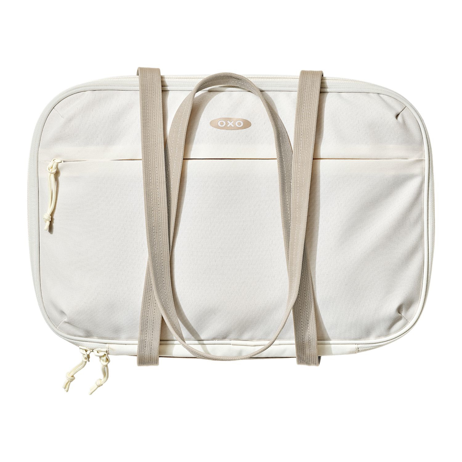 Tan OXO Good Grips Insulated Bakeware Carrier with durable exterior fabric, insulated interior with aluminum lining, generous carry handles, and a front zippered pocket, designed to transport 9 x 13-inch bakeware and keep hot or cold dishes at temperature during potlucks, parties, and family gatherings.