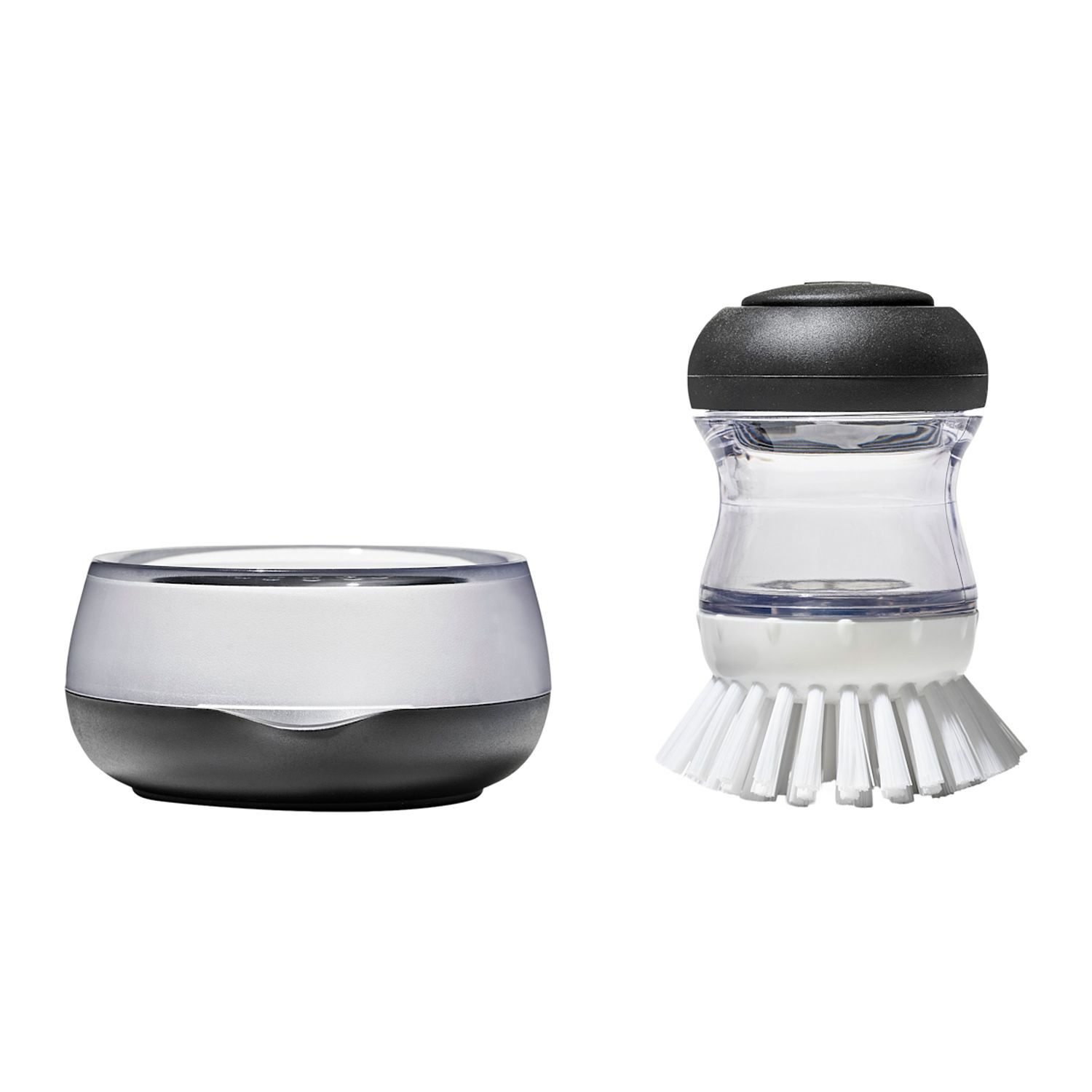 Black OXO Good Grips Soap Dispensing Palm Brush Storage Set with compact countertop holder, white and gray design, durable nylon bristles, and soap-dispensing palm brush for convenient dishwashing and kitchen cleanup.