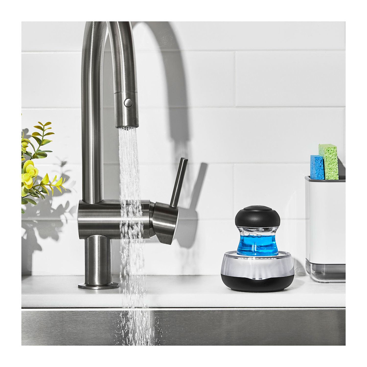 Black OXO Good Grips Soap Dispensing Palm Brush Storage Set with compact countertop holder, white and gray design, durable nylon bristles, and soap-dispensing palm brush for convenient dishwashing and kitchen cleanup.