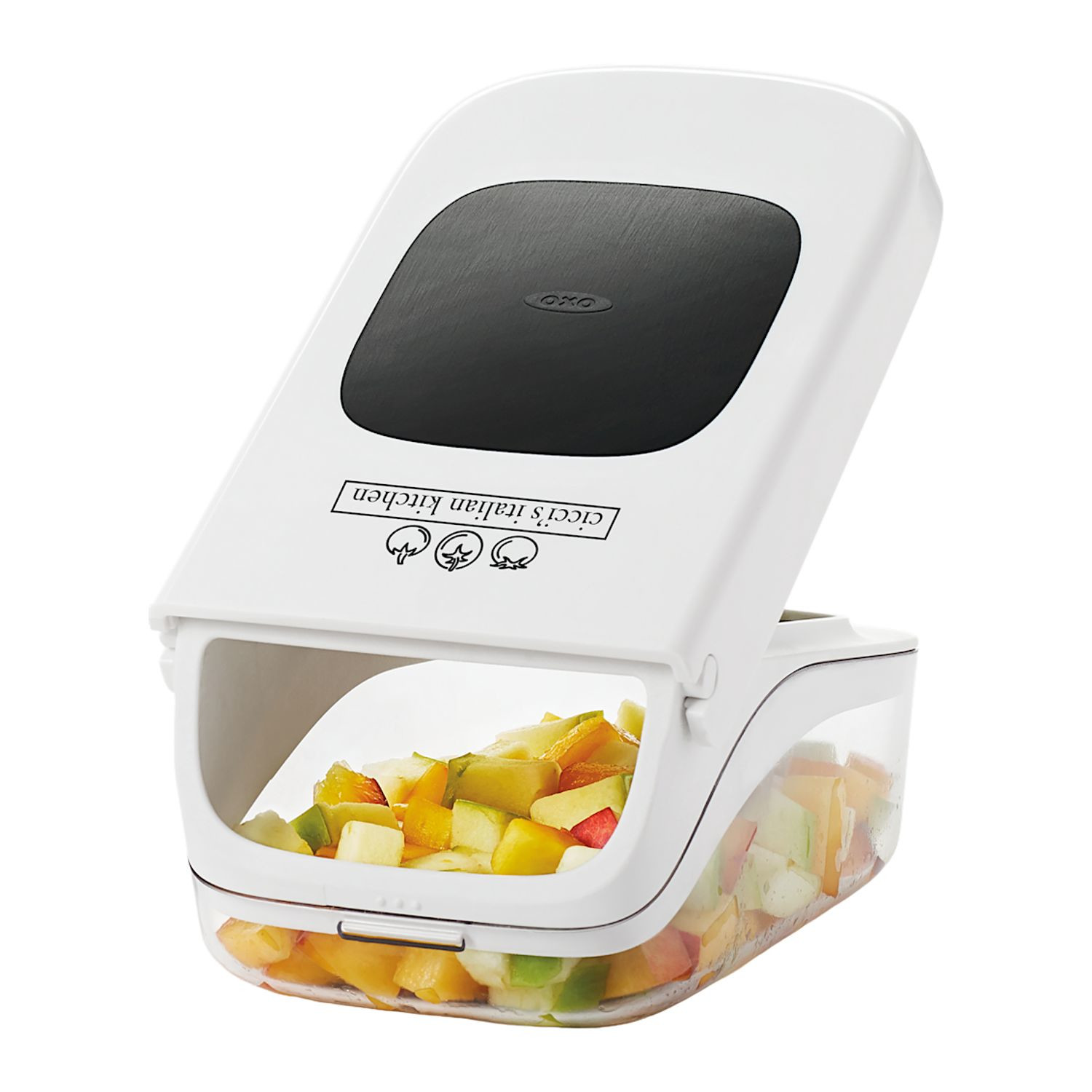 White OXO Good Grips Vegetable Chopper with Easy-Pour Opening, featuring a compact white and clear plastic container, black leverage-assist lid, and stainless steel chopping blades, designed for quickly chopping vegetables, fruits, onions, and peppers.