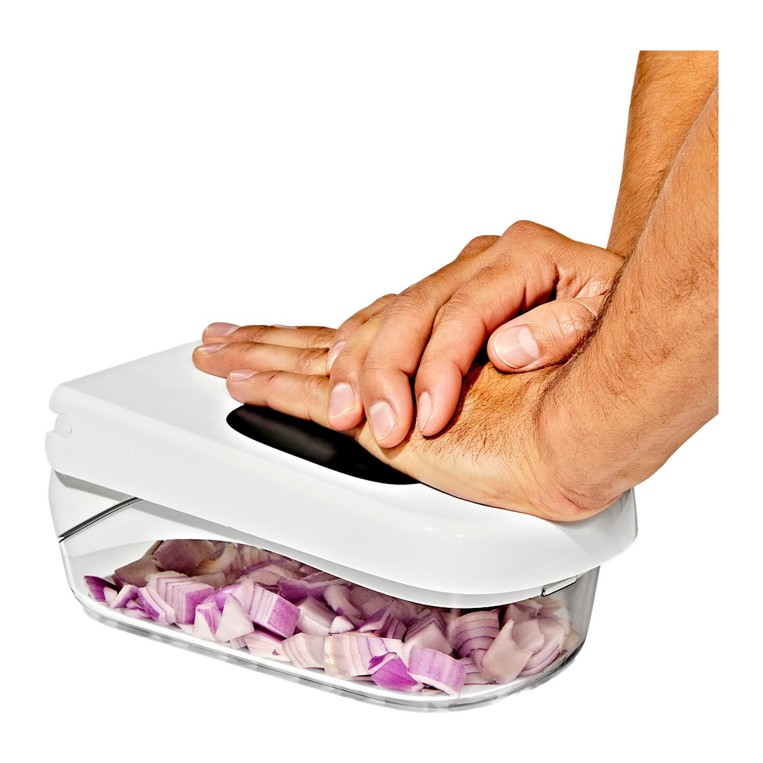 White OXO Good Grips Vegetable Chopper with Easy-Pour Opening, featuring a compact white and clear plastic container, black leverage-assist lid, and stainless steel chopping blades, designed for quickly chopping vegetables, fruits, onions, and peppers.