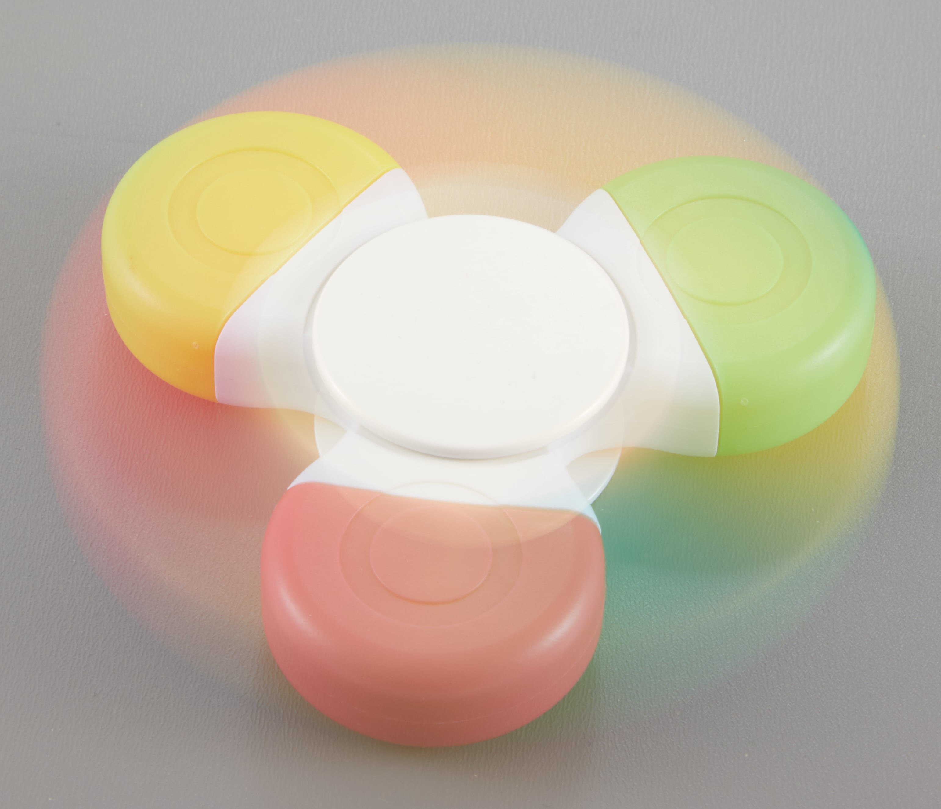 Multi-Ink Spinner Highlighter made of recycled ABS plastic, featuring a compact three-color red, green, and yellow highlighter design with a built-in fidget spinner for studying, note-taking, and color-coding documents.