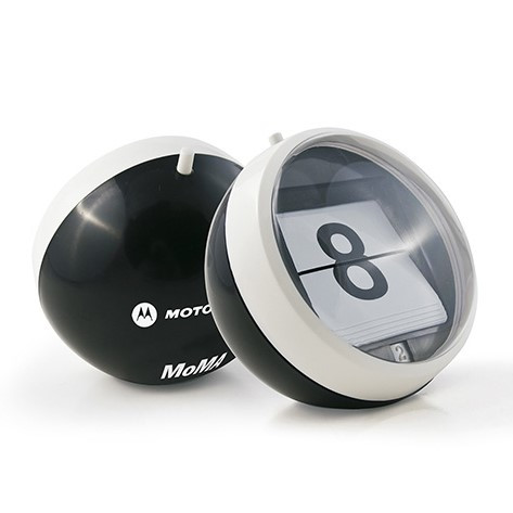 Black perpetual calendar with adjustable day button, rotating month dial, MoMA logo on the bottom, and black gift box.