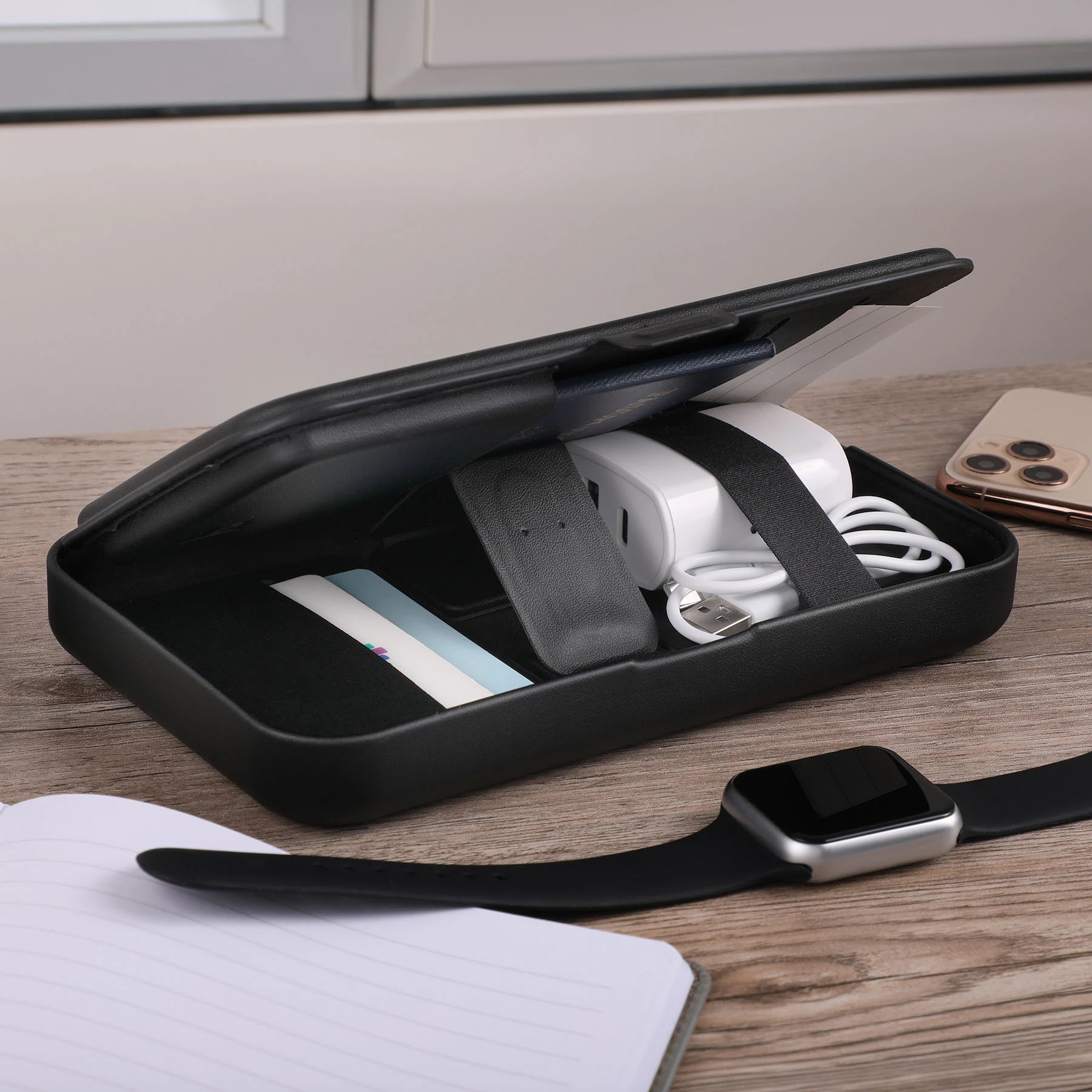 Wireless charging for phone, earbuds, and watch; hard shell carrying case; magnetic lid closure; adjustable magnetic dividers; magnetic lid doubles as a stand