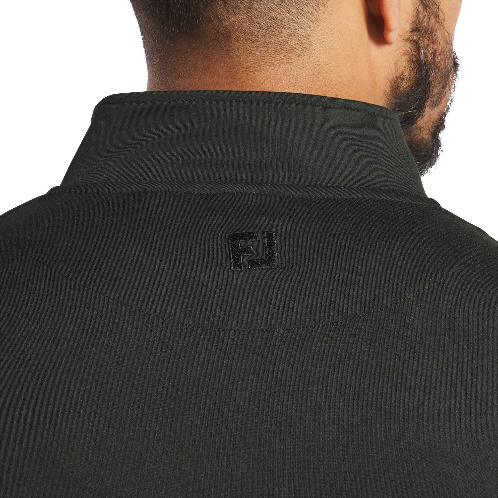 Black FootJoy® Men’s Performance Quarter-Zip Pullover, featuring a lightweight polyester-spandex stretch fabric, stand collar, quarter-zip front, and long sleeves, designed for comfortable layering during golf and active wear.