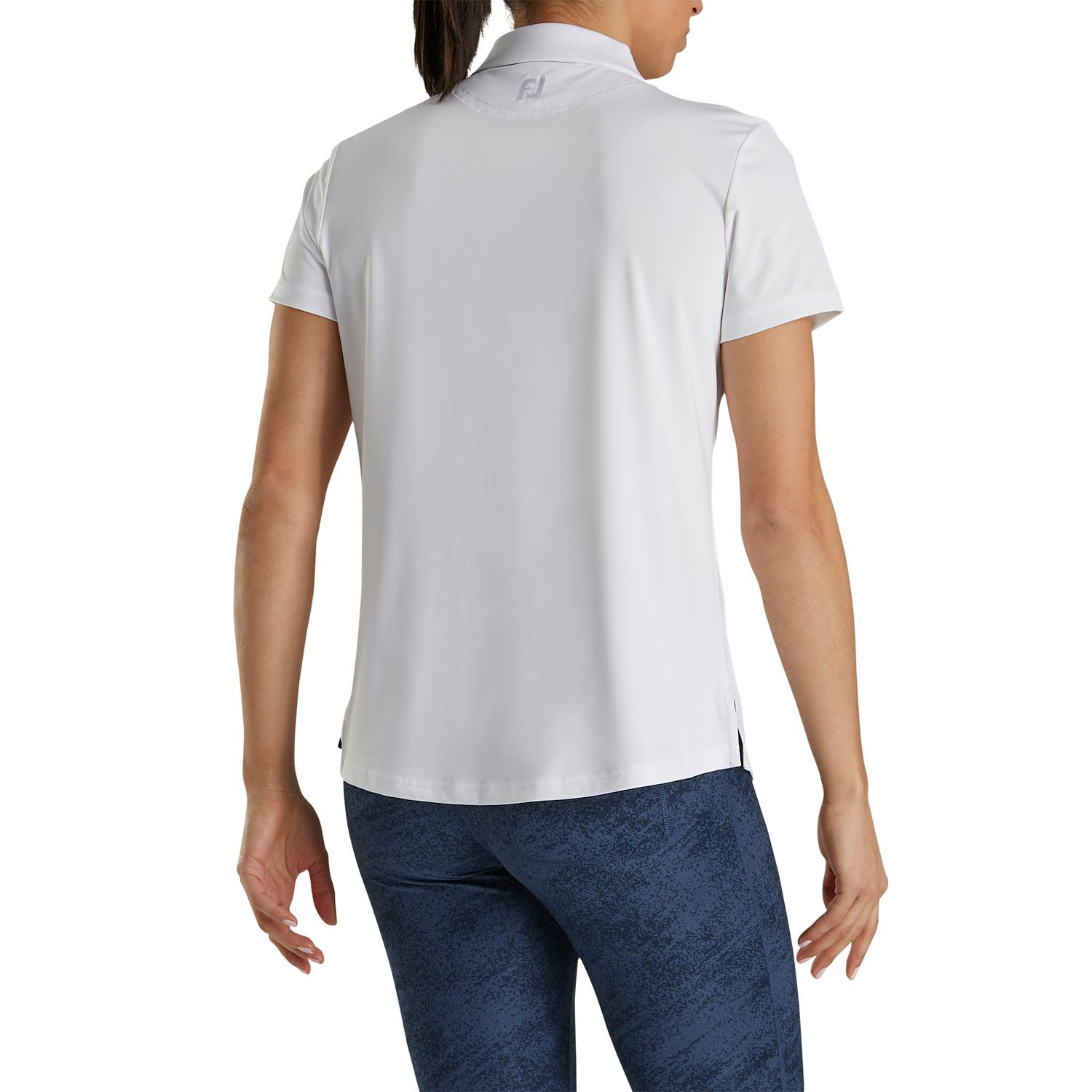 White FootJoy Women’s Solid Lisle Performance Golf Polo made from stretch polyester-spandex fabric with moisture-wicking technology, anti-microbial finish, four-way stretch, and extended back shirt tail for golf or active wear.