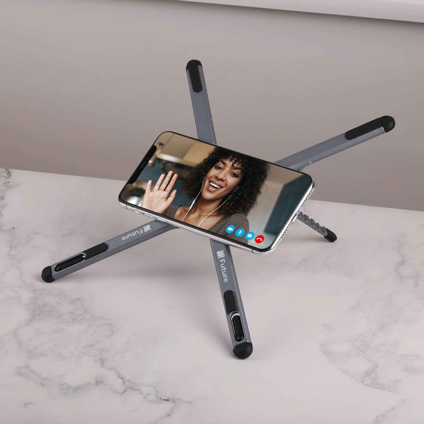 Gray Magnix Portable Travel Laptop Stand Compact, adjustable laptop stand with sleek metal legs and a magnetic phone mount, shown in a modern metallic finish. Folds flat for easy travel and supports laptops, tablets, and phones for portable workspaces.