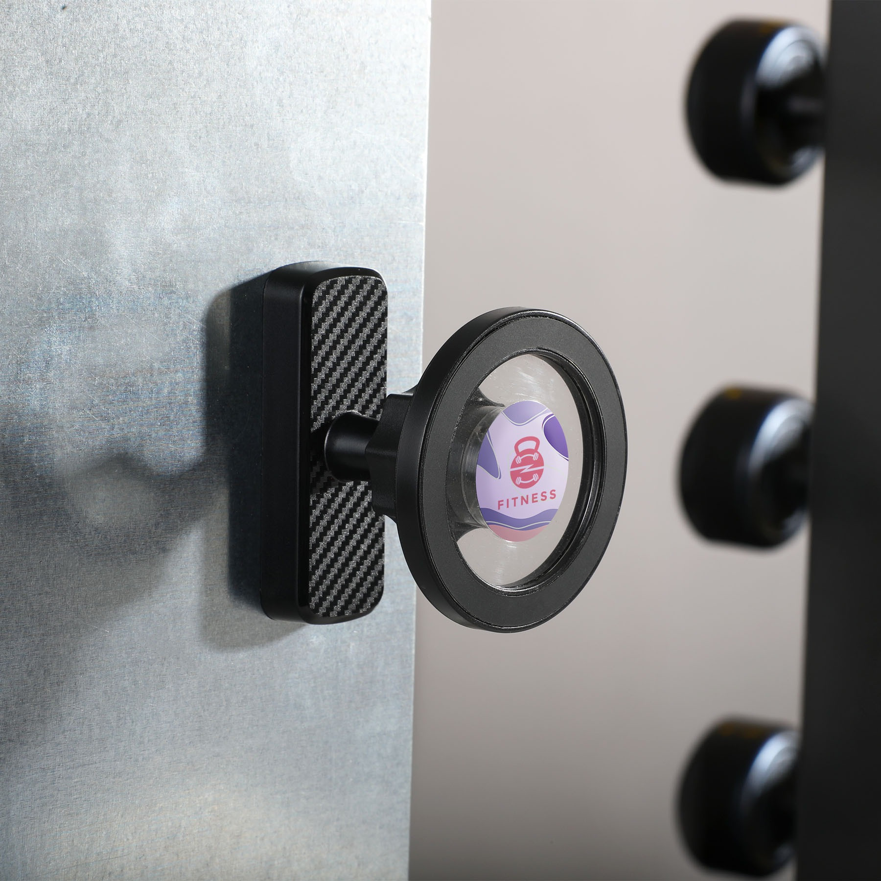 Black MagGrab Magnetic Phone Mount with compact silver circular design, built-in phone-holding magnet, adjustable viewing angle, and metal-gripping back for mounting phones on golf carts, garages, and other metal surfaces.