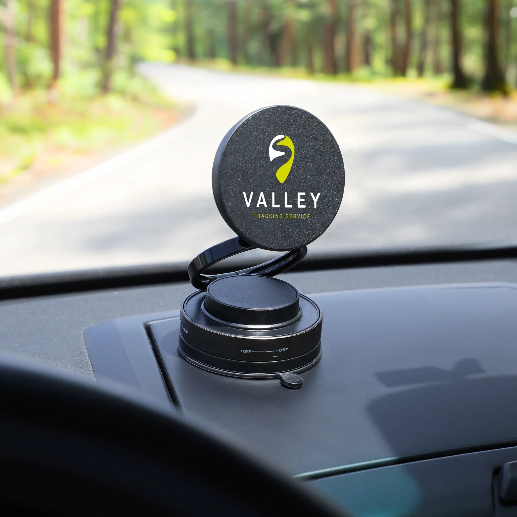 Black Lunogrip Charge Phone Stand & Wireless Charger in black, compact adjustable design with a magnetic charging pad and suction cup base for hands-free phone charging on smooth surfaces.